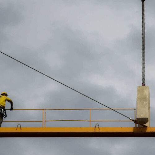 man-stand-on-crane